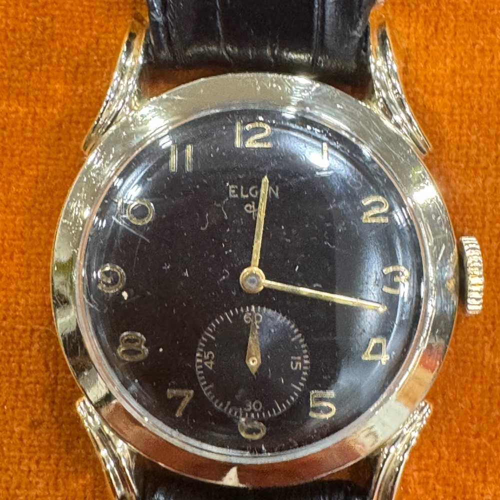 Elgin Men's Black and Gold Watch
10 karat gold, filled Bezel
